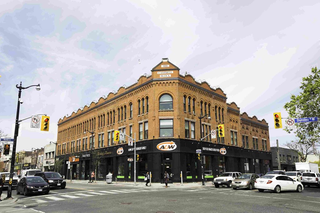 a large brick building on the corner of a city street