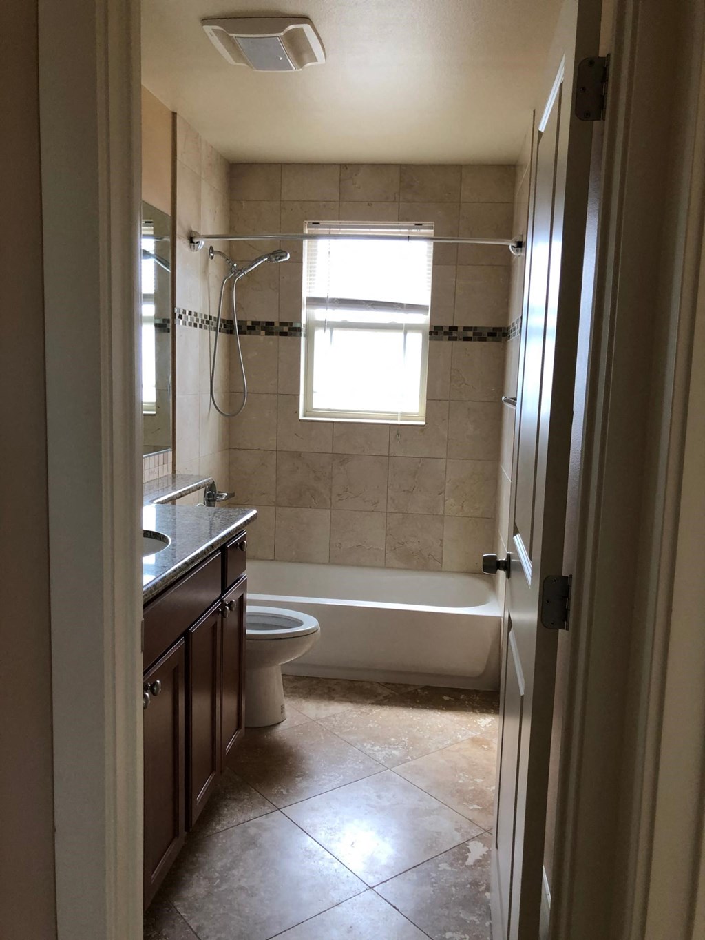 a small bathroom with a shower toilet and sink