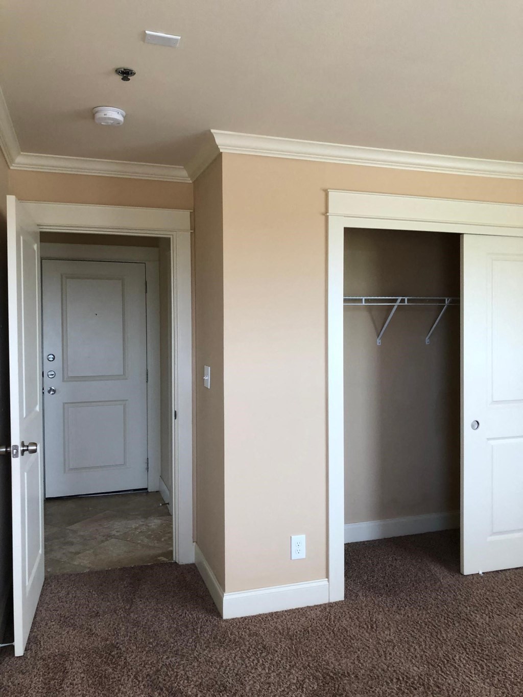 a bedroom with a closet and a closet door and a white door to a closet