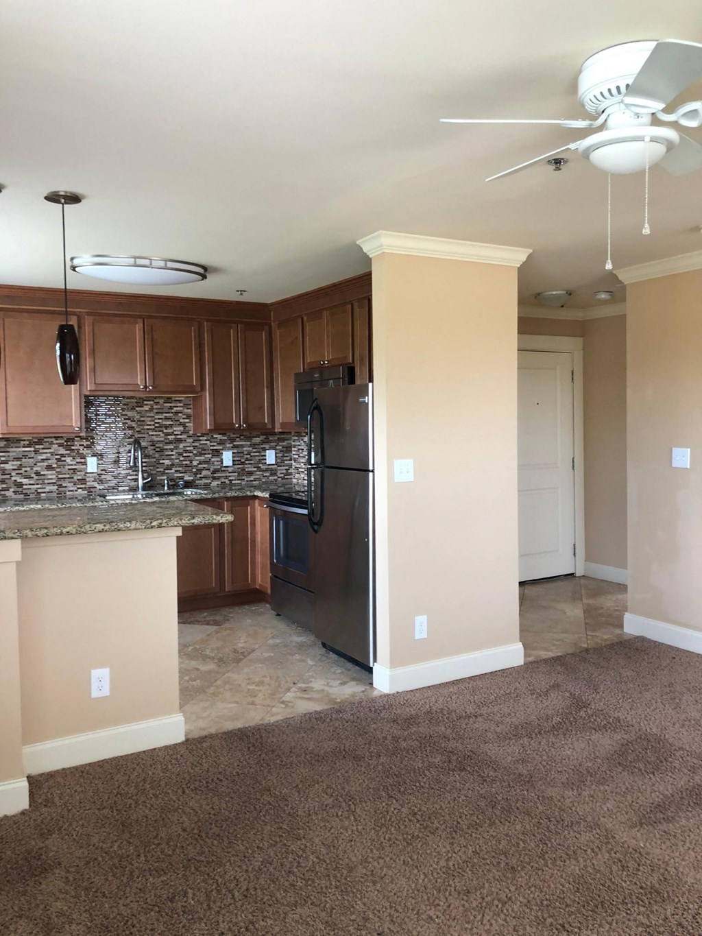 a kitchen with a stainless steel refrigerator and a counter top
