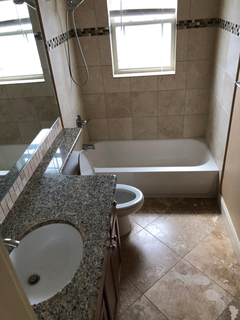 a bathroom with a sink and a toilet and a bath tub