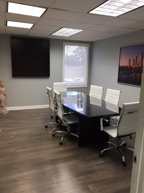 A conference room with a long table and chairs.