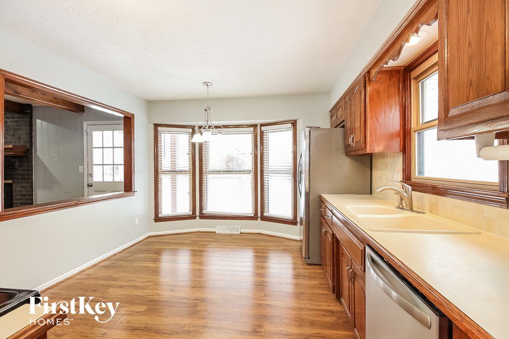 a kitchen with wooden cabinets and a sink and a window