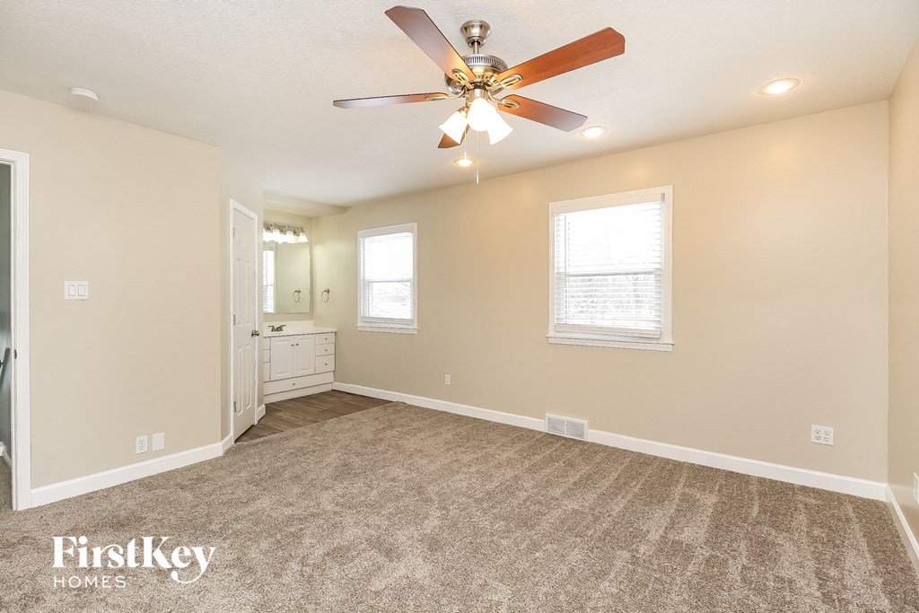 the master bedroom is spacious and has a ceiling fan