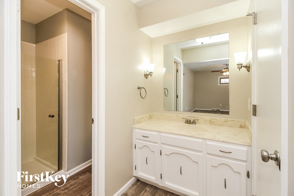 a bathroom with a sink and a mirror and a shower