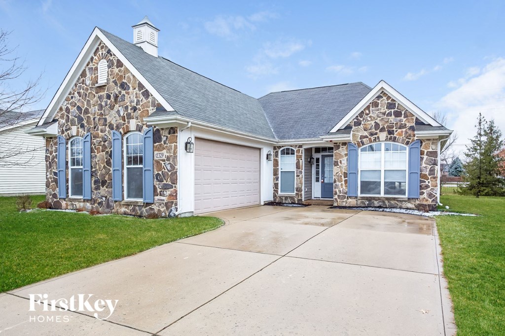 the front of a house with a driveway and a garage door