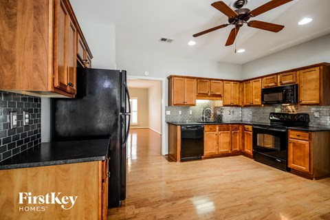 a kitchen with black appliances and wooden cabinets