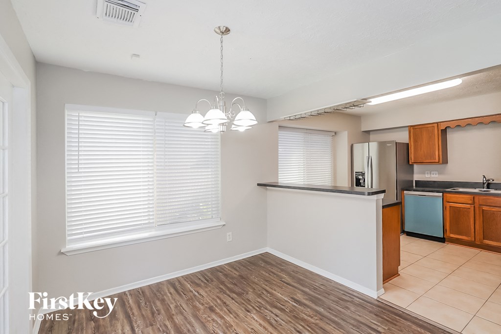 a kitchen and dining room with a large window