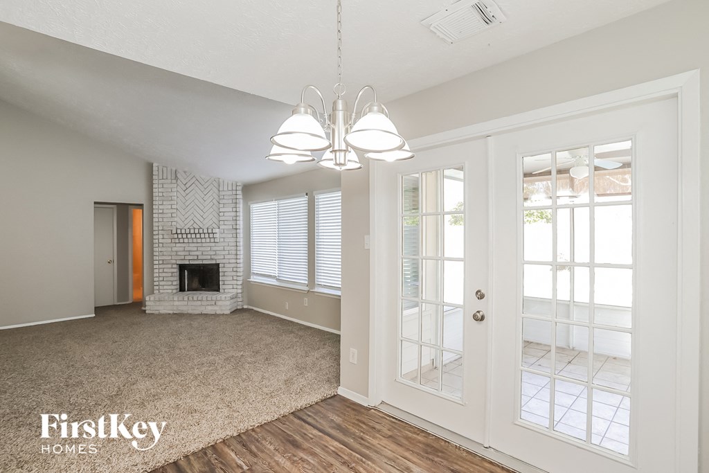 a living room with a fireplace and doors