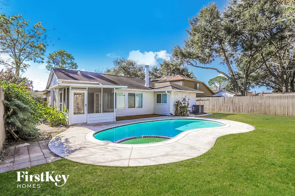 a backyard with a pool and a house