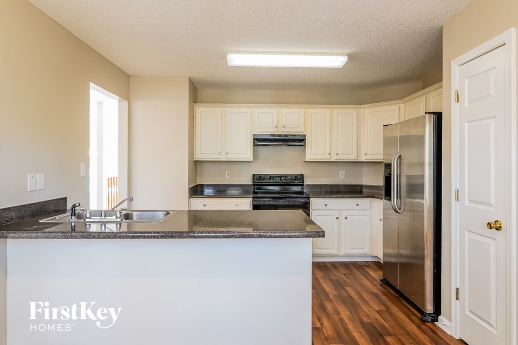 A kitchen with a counter top and a refrigerator.