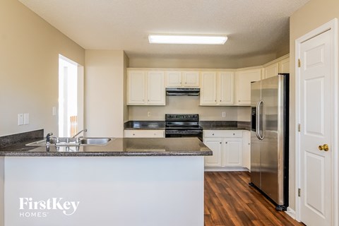 A kitchen with a counter top and a refrigerator.