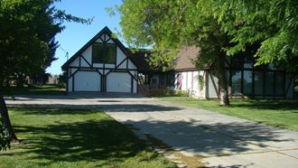 a house with a garage and a sidewalk in front of it