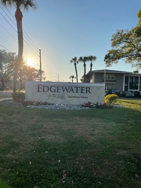 A sign that says Edgewater in front of a house.