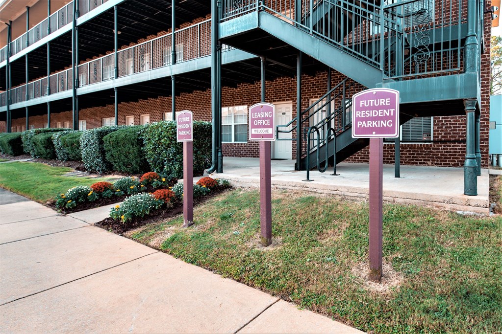 three parking signs in front of a building