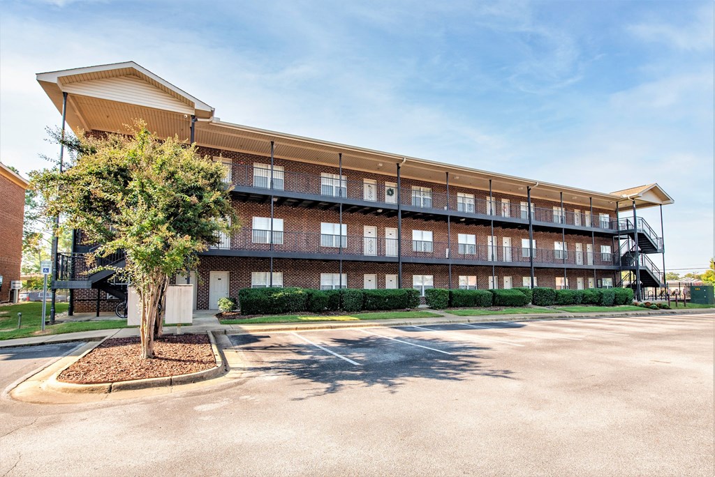 a large brick building with a tree in front of it