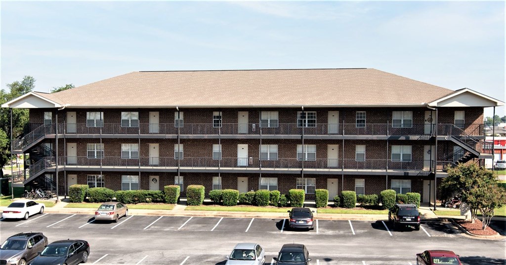 a large building with cars parked in a parking lot