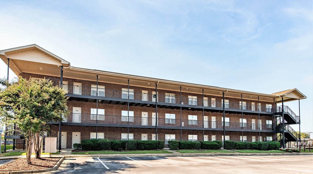 a brick building with a tree in front of it
