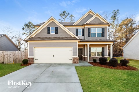 a home with a white garage door in front of it