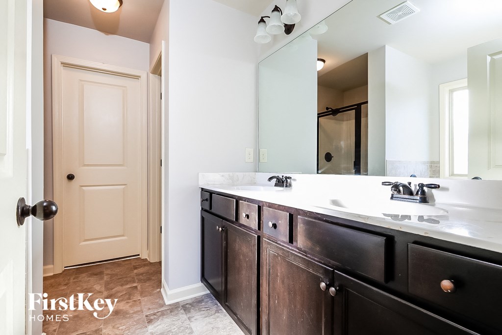a bathroom with two sinks and a large mirror