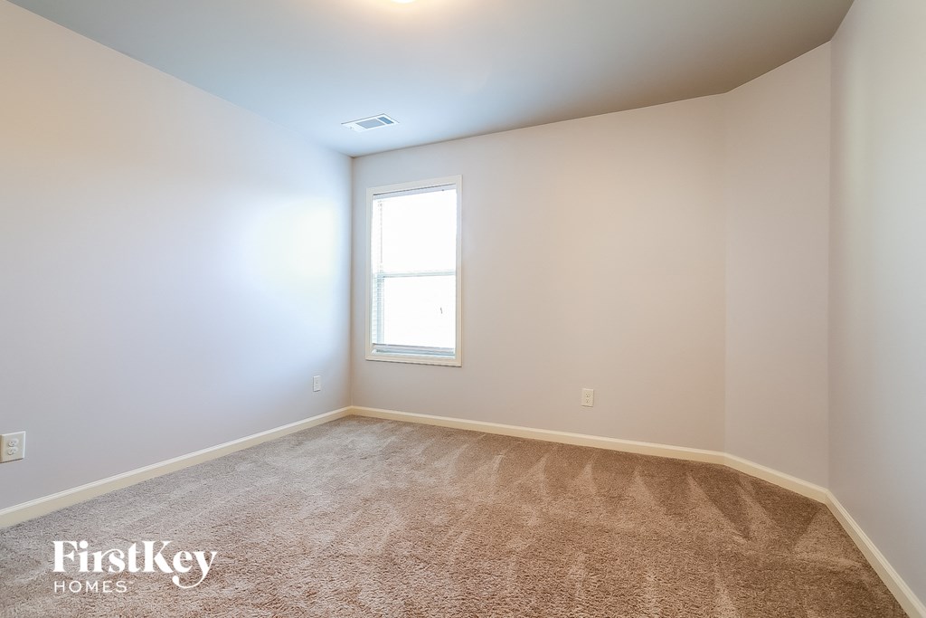 a room with carpet and a window in it