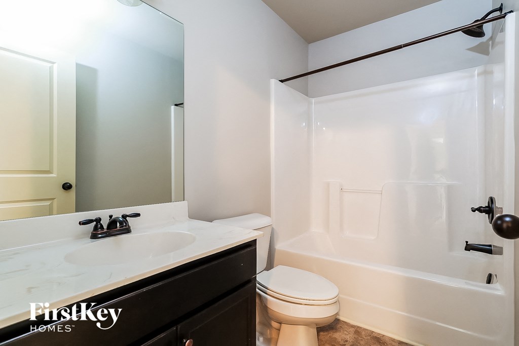 a bathroom with a sink toilet and a shower