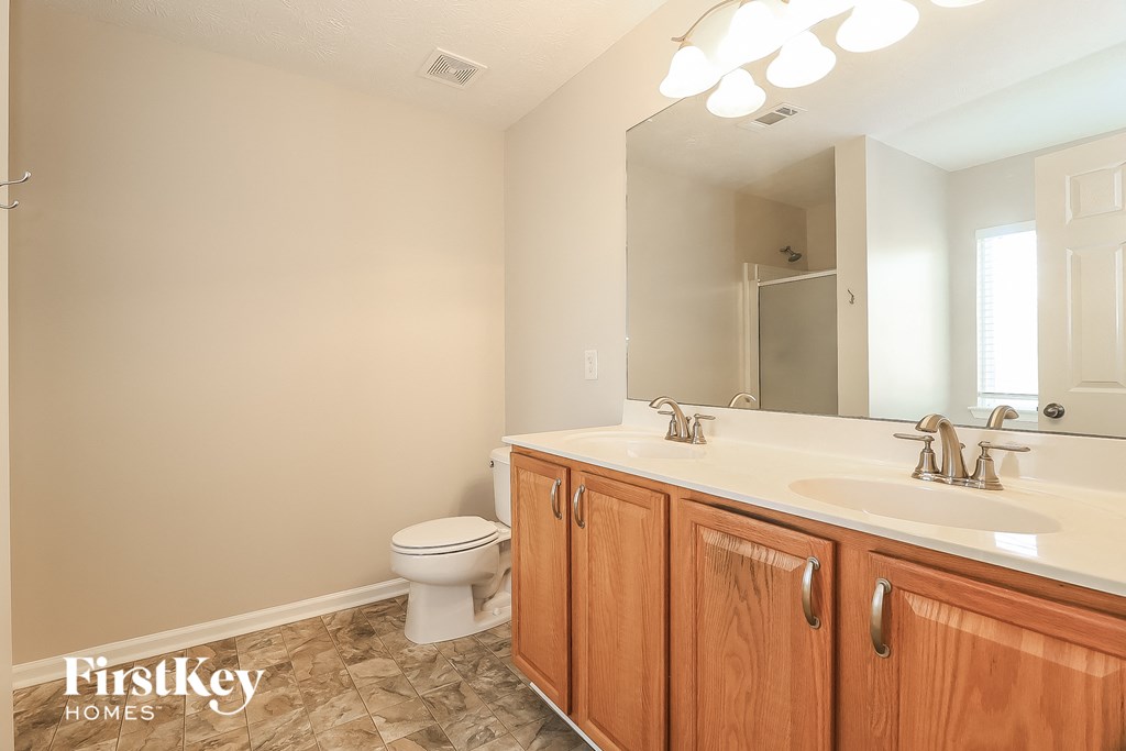 a bathroom with a sink and a toilet and a mirror