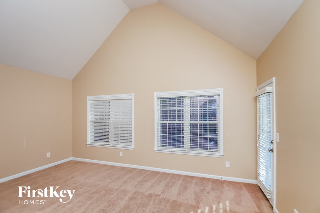 A room with beige walls and a wooden floor.