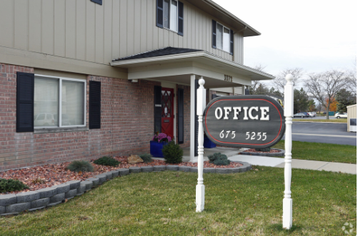 a sign for an office in front of a house