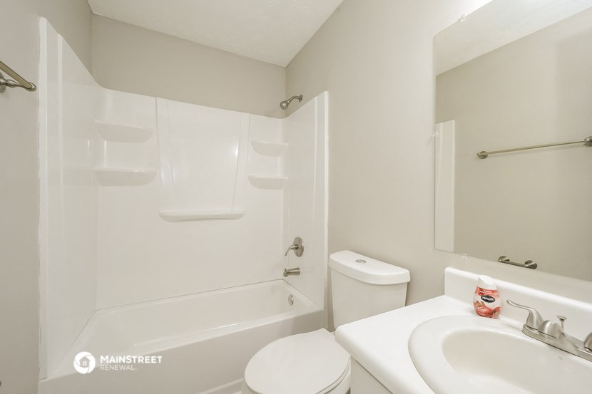 a bathroom with a sink toilet and a bath tub