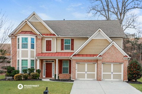 a brick house with a sidewalk in front of it