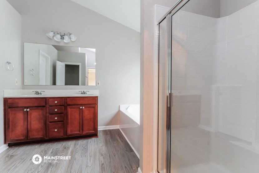 a bathroom with a shower and a sink and a mirror