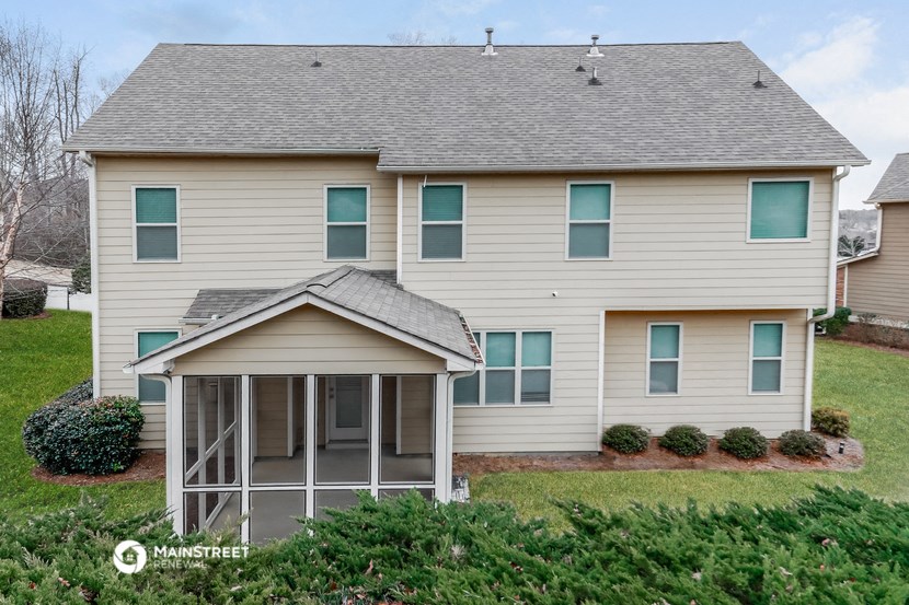 a white house with a screened in porch
