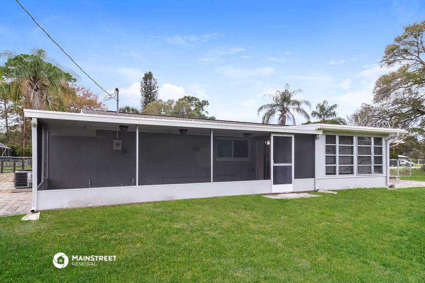 a small grey and with a grassy yard