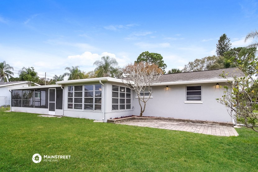 a white house with a yard and a lawn
