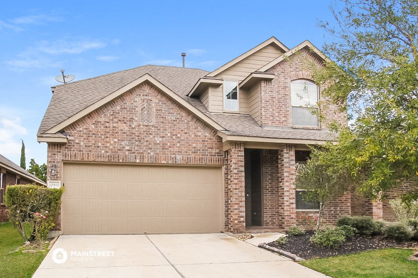 a house with a garage door in front of it