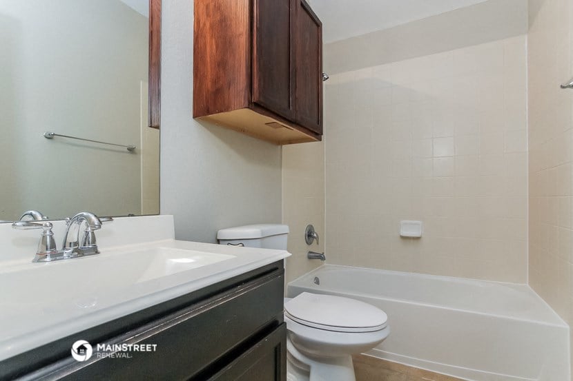 a bathroom with a sink toilet and a bath tub