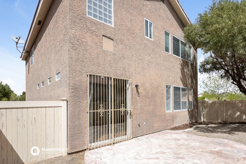a large brick building with a gate and a driveway