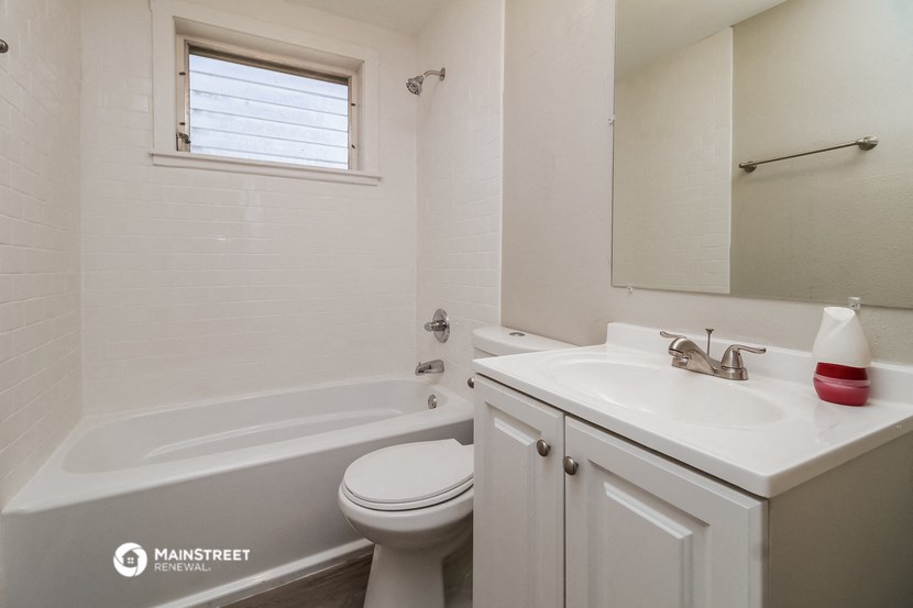 a bathroom with a sink toilet and a bath tub
