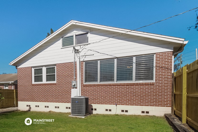 the front of a brick house with a white roof