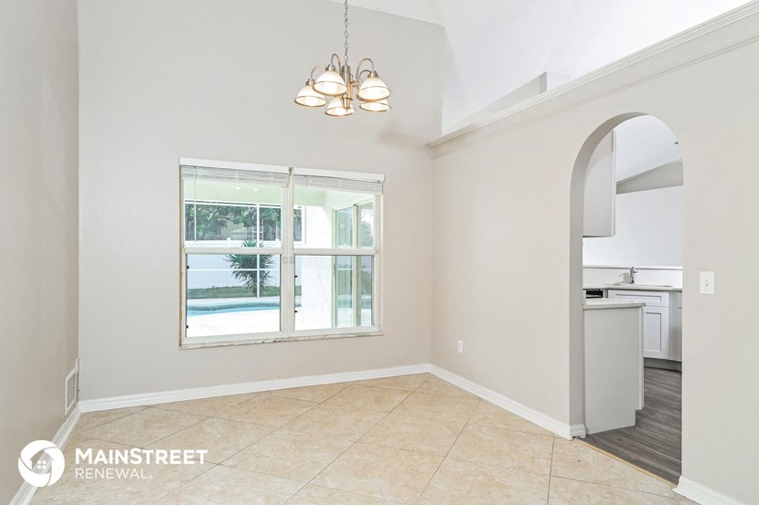 an empty living room with a view of a swimming pool