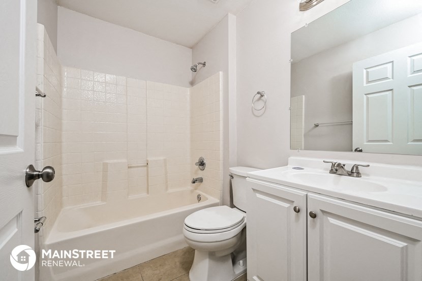 a white bathroom with a sink toilet and tub