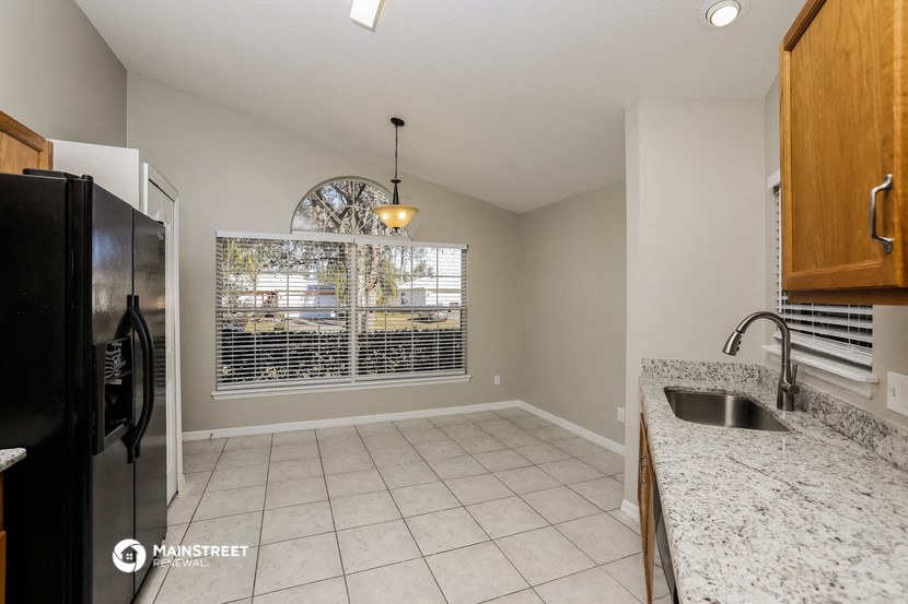 an empty kitchen with a sink and a window