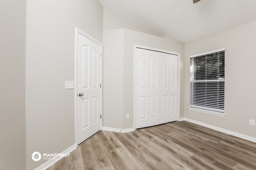 the bedroom of our studio apartment atrium with two doors and a window