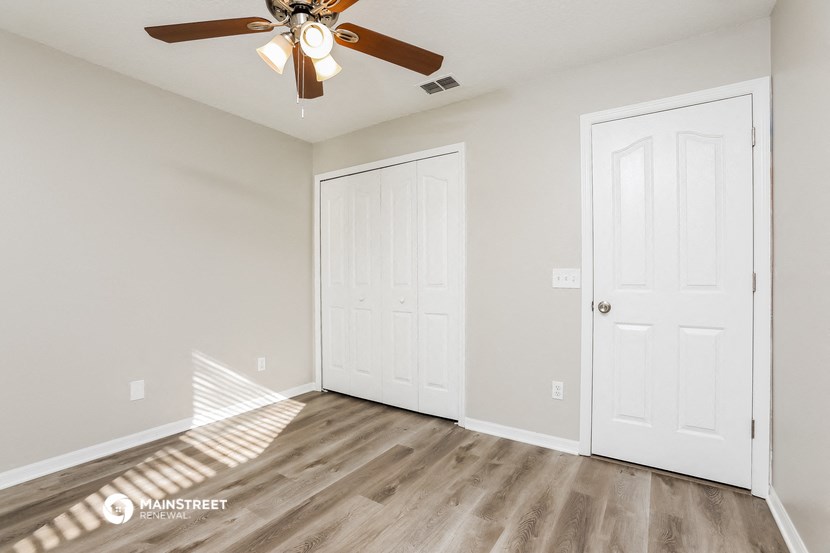 the living room of our studio apartment atrium with a ceiling fan