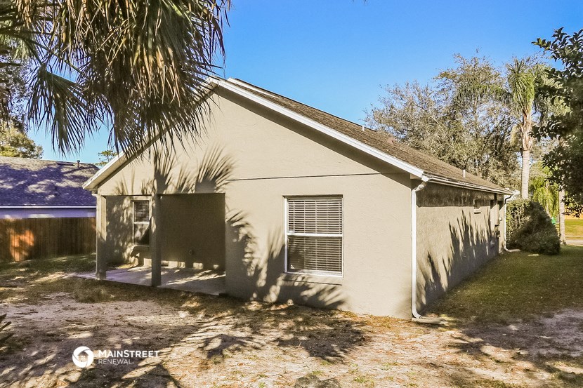 a small house with a palm tree in front of it