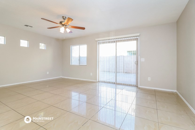 the spacious living room with sliding glass doors to the patio