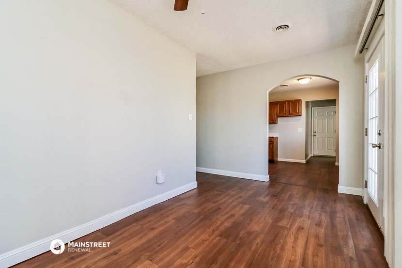 the living room and dining room of an empty renovated house