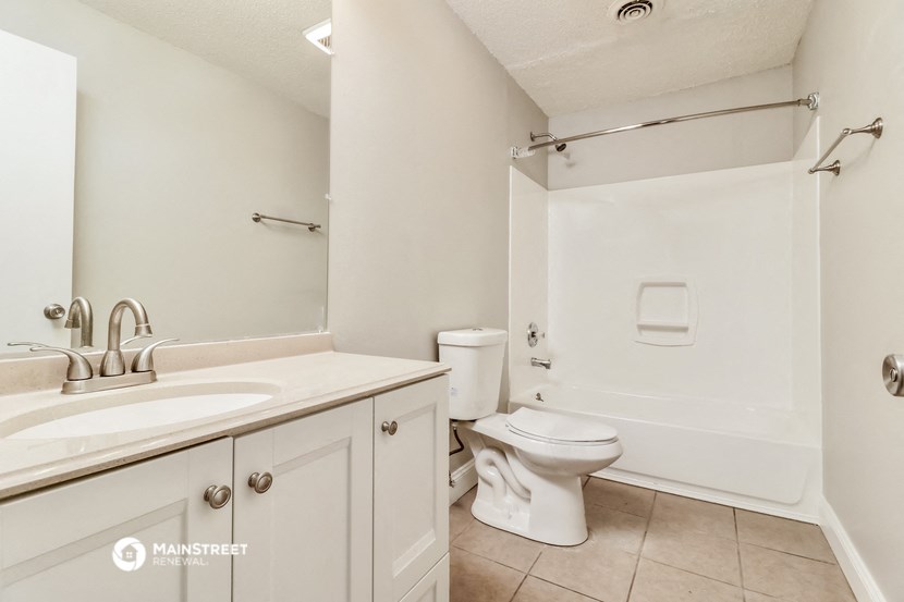 a bathroom with a sink and a toilet and a shower