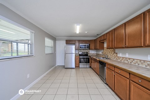 a kitchen with wooden cabinets and a window